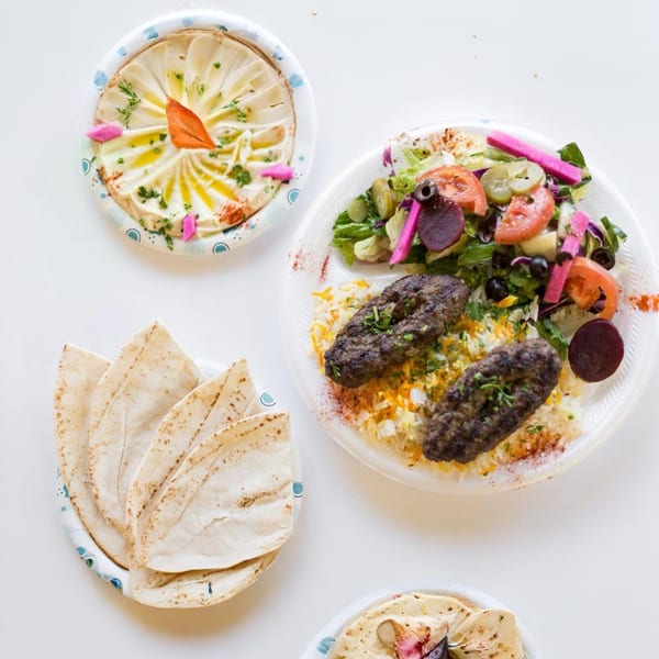Maira Mediterranean Grill's kofta plate with rice, salad, hummus, and pita bread.
