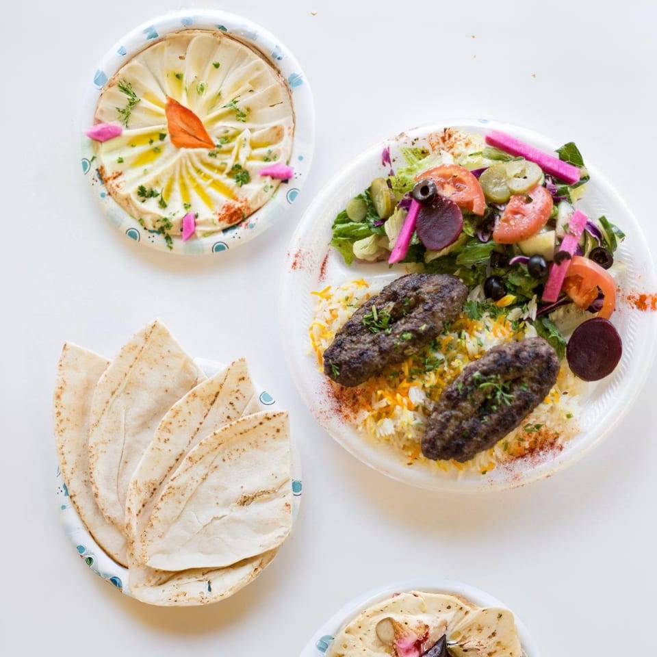 Maira Mediterranean Grill's kofta plate with rice, salad, hummus, and pita bread.