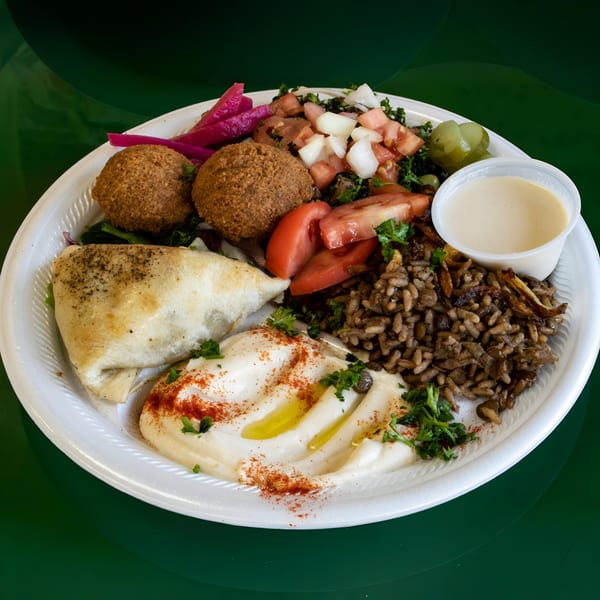 Maira Mediterranean Grill's falafel plate with hummus, rice, salad, pita, and pickled vegetables.